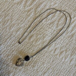 Long silver tone locket necklace with amethyst stone